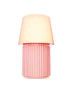 Kono Blush table lamp by Lempori illuminated with warm white LED light on a white background.