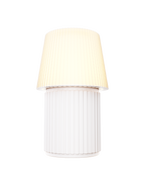 Kono Ivory table lamp by Lempori illuminated with warm white LED light on a white background.