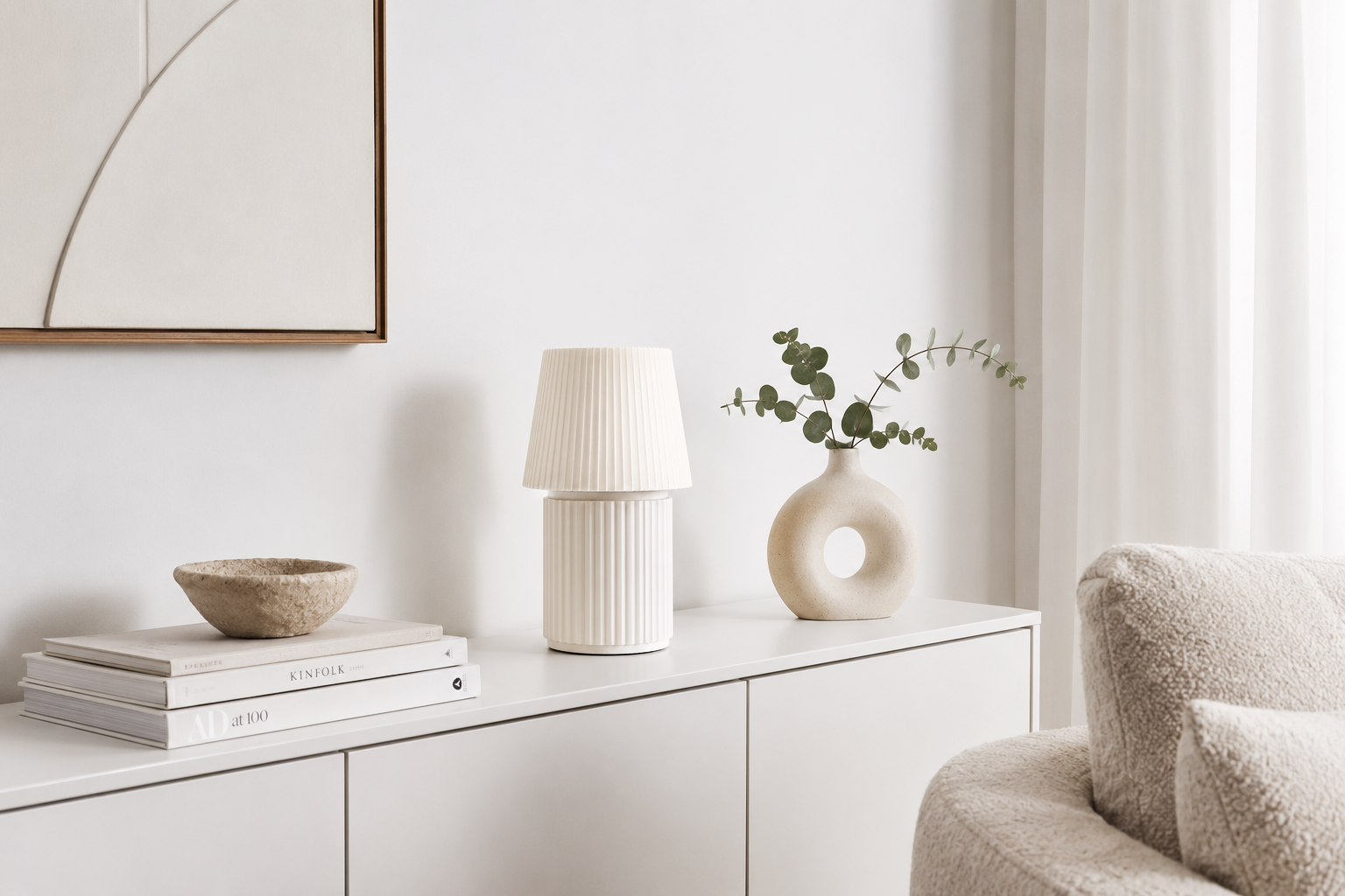 Kono Ivory table lamp by Lempori styled on a white sideboard in a bright Scandinavian-inspired living room.
