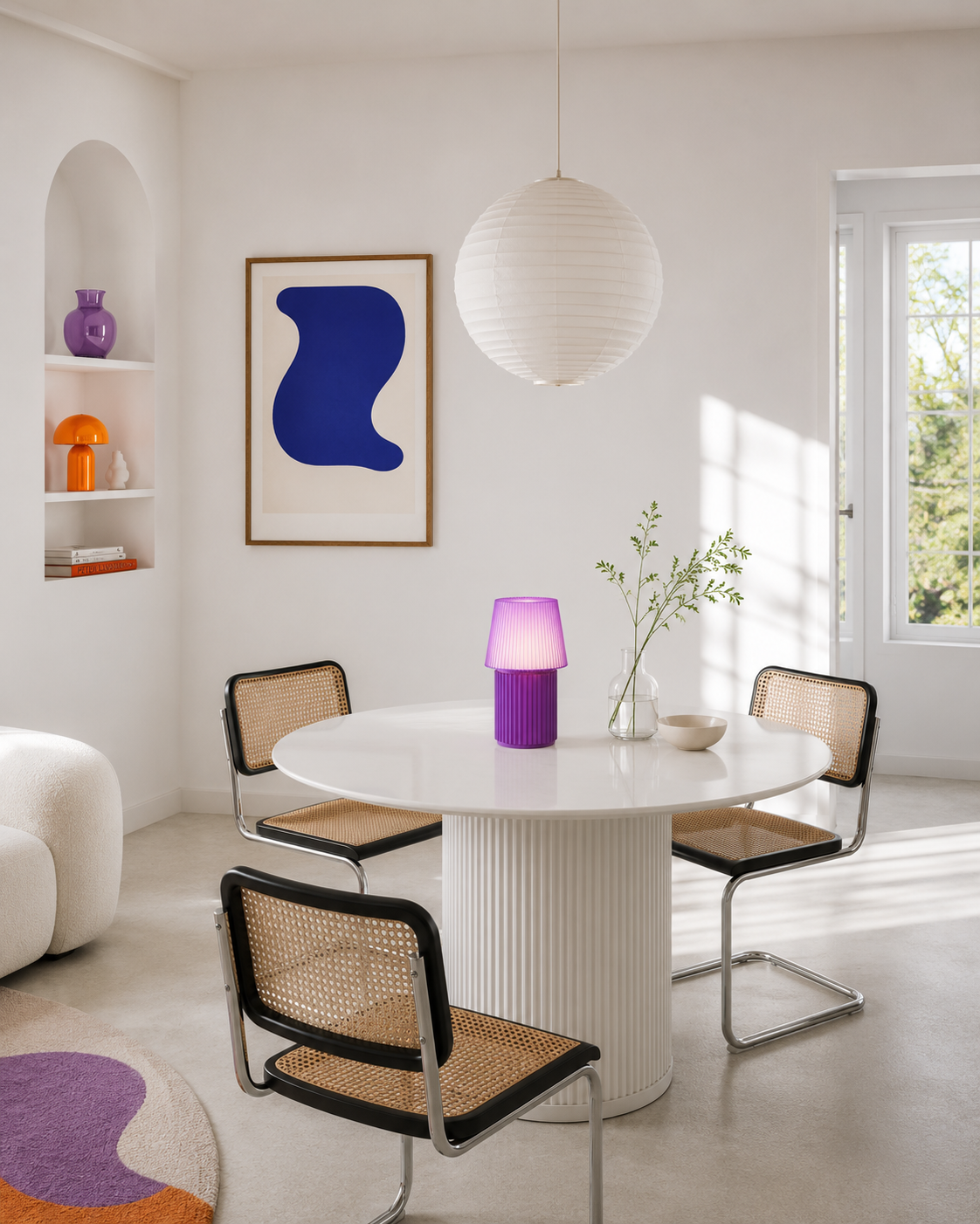 Kono Lavender table lamp by Lempori illuminated on a round dining table in a bright modern interior with purple accents.